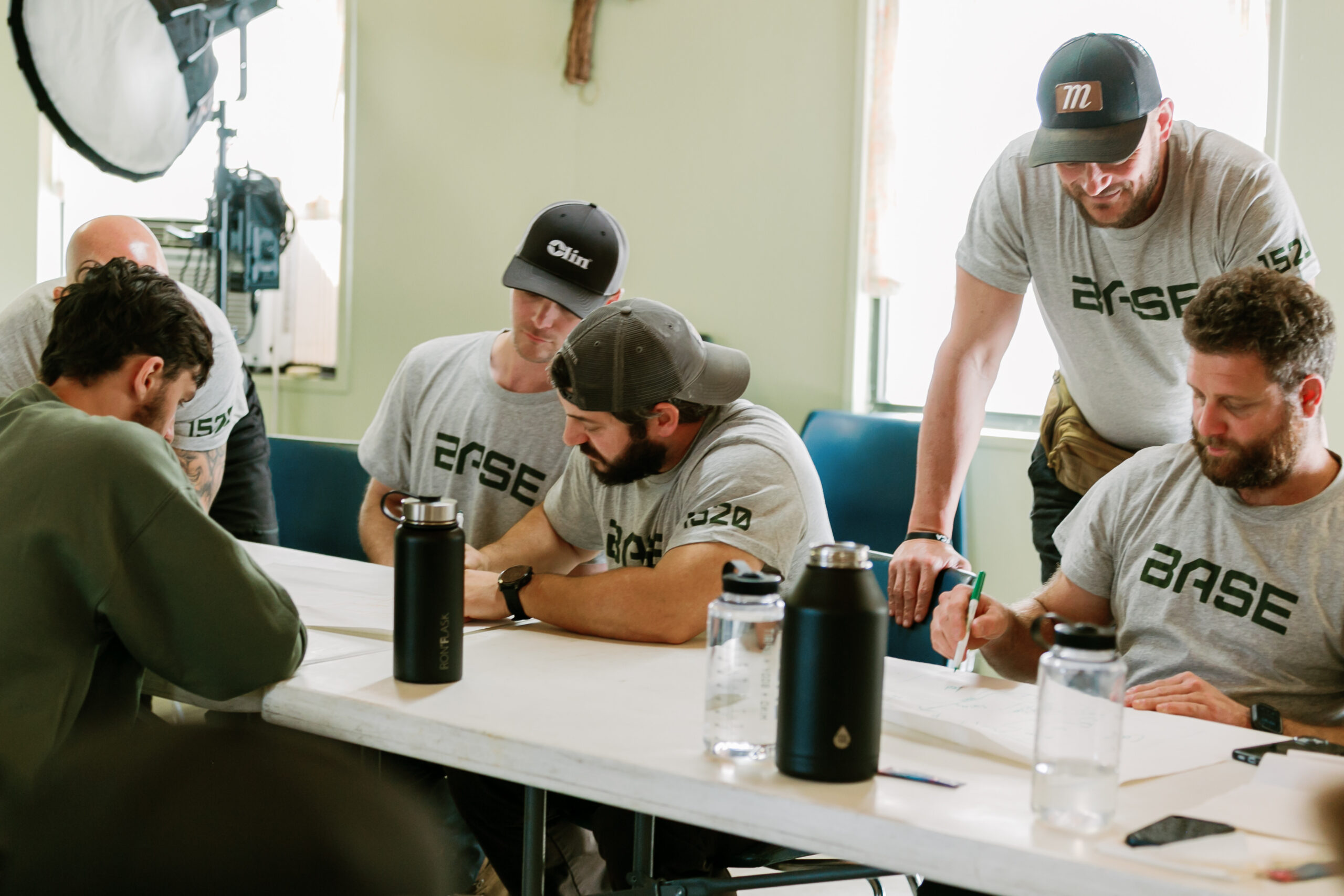 Men gathered for a mission briefing at a BASE 1520 event